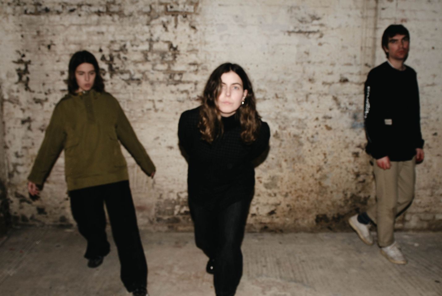 Trio Voka Gentle stood in front of a brick wall